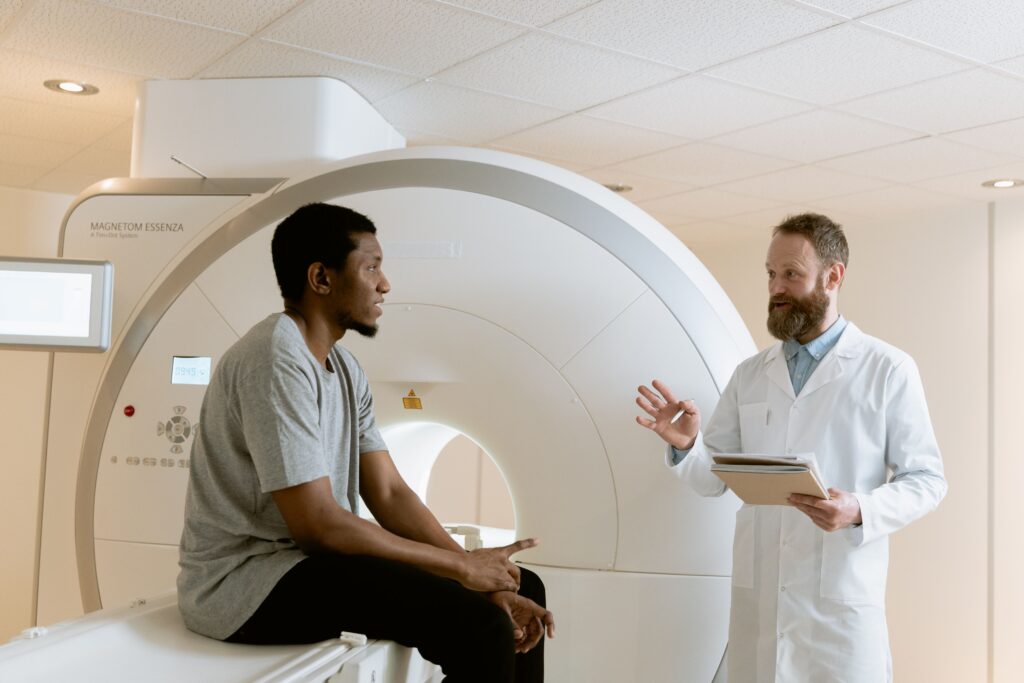 Doctor discussing MRI scan results with patient in a medical facility.